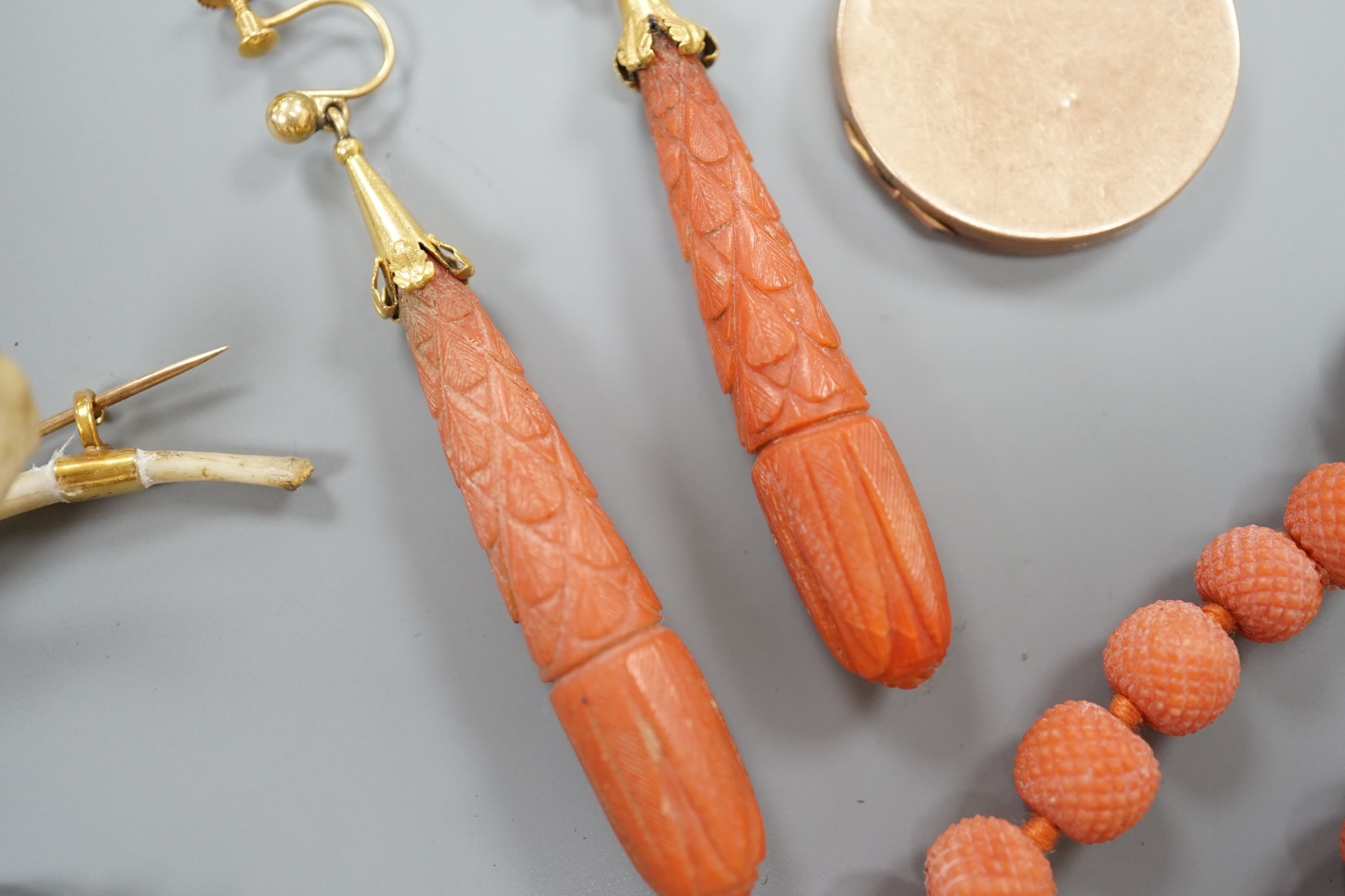 A pair of 9ct mounted teardrop shaped carved coral drop earrings, 6cm, gross 14.7 grams, a carved coral bead bracelet with yellow metal and carved coral bust set clasp, gross 20.5 grams and four other items including a 9